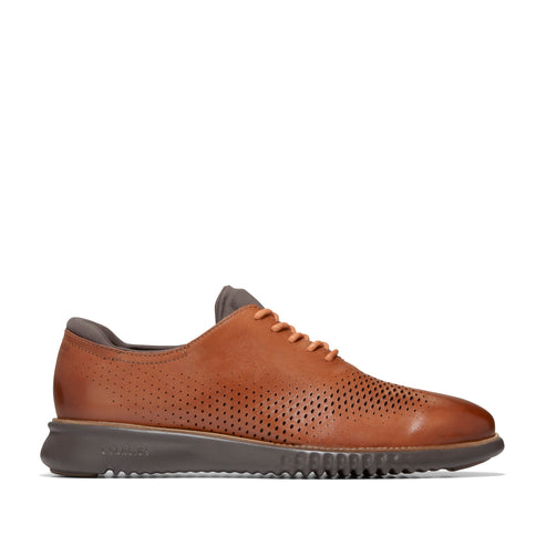 Brown perforated dress shoe with a low profile.
