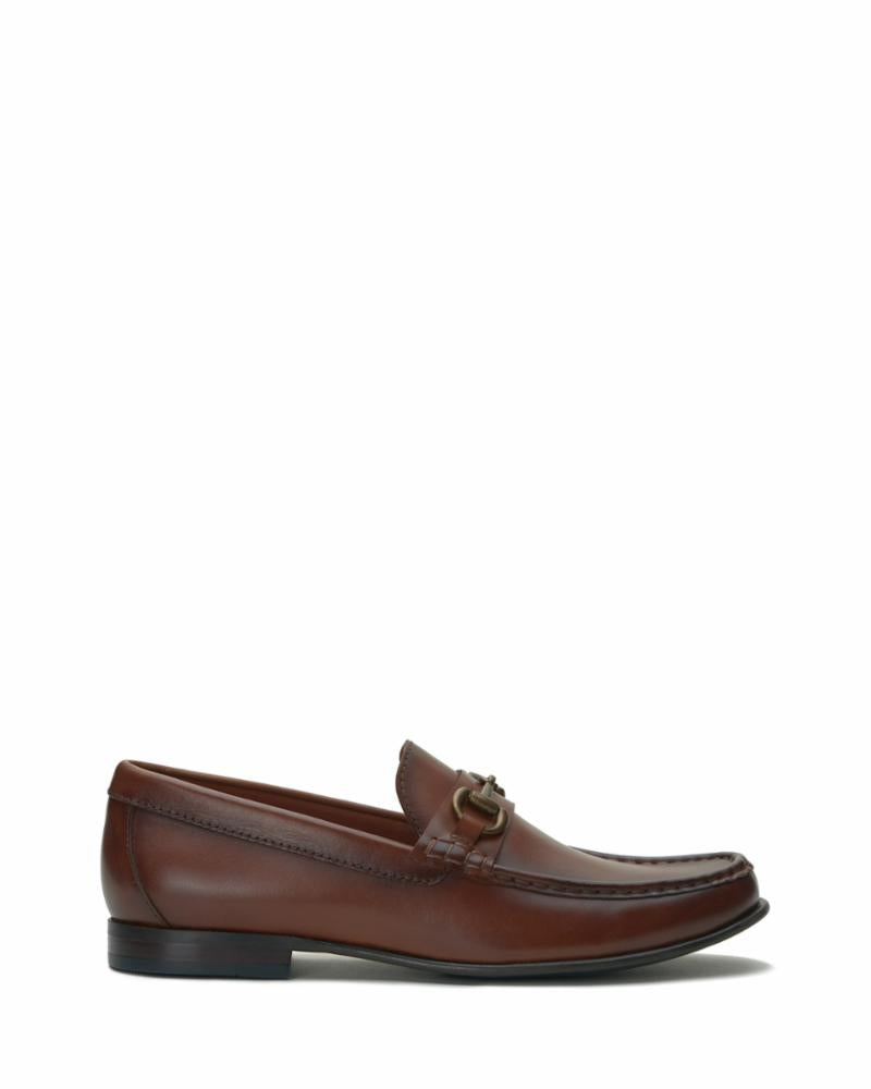 A brown leather loafer with a gold-toned buckle.