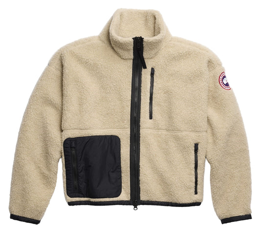Tan sherpa fleece jacket with black zipper, chest pocket, and logo patch on the right arm.