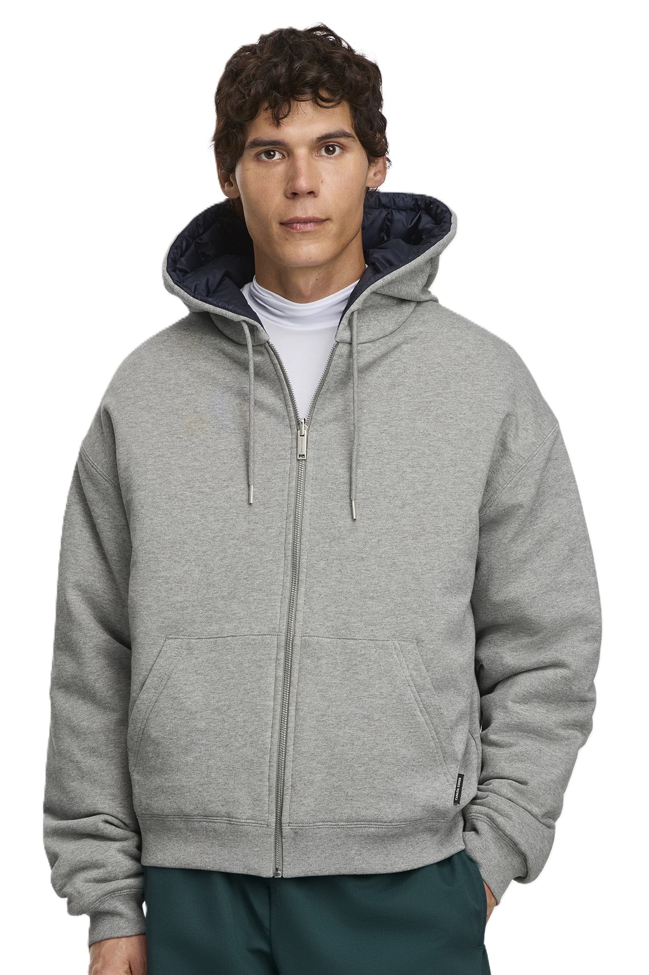 Man in gray zip-up hooded sweatshirt with dark blue lining.