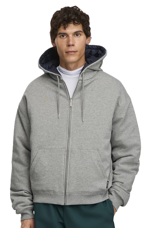 Man in gray zip-up hooded sweatshirt with dark blue lining.