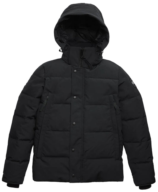 A black, hooded, down-filled puffer jacket with a front snap-button placket covering the zipper, long sleeves with ribbed cuffs, and a small circular logo patch on the left upper sleeve.