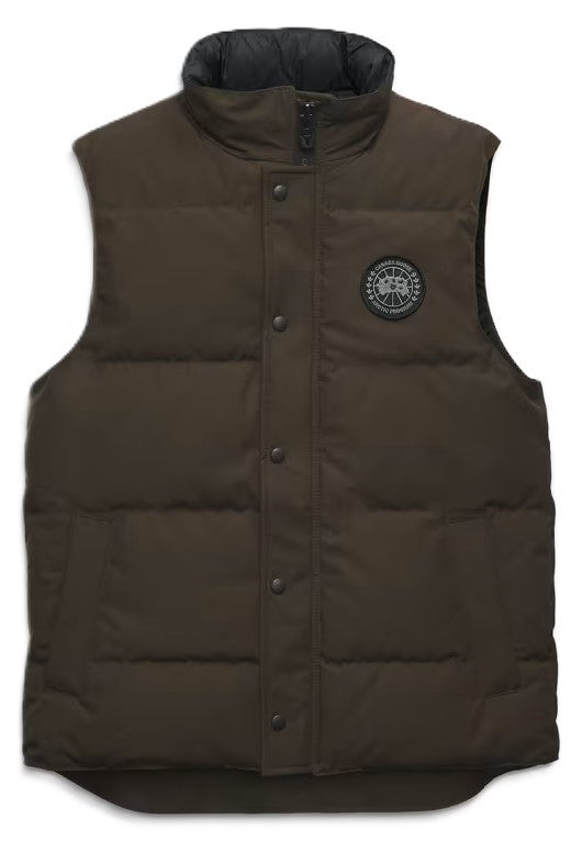 Sleeveless, brown puffer vest with button-up front and circular patch emblem.