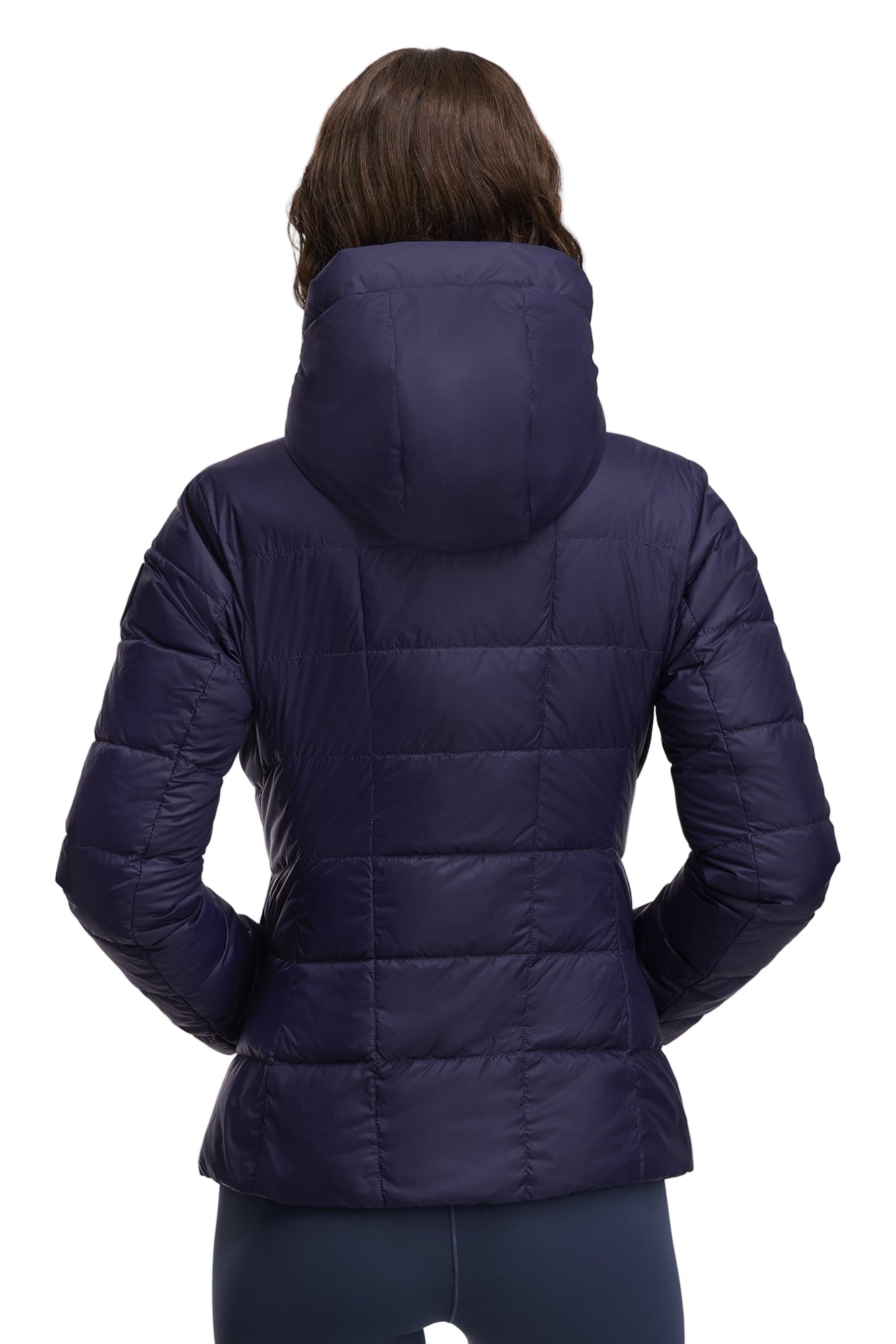 Back view of a woman wearing a quilted, hooded, navy blue jacket.