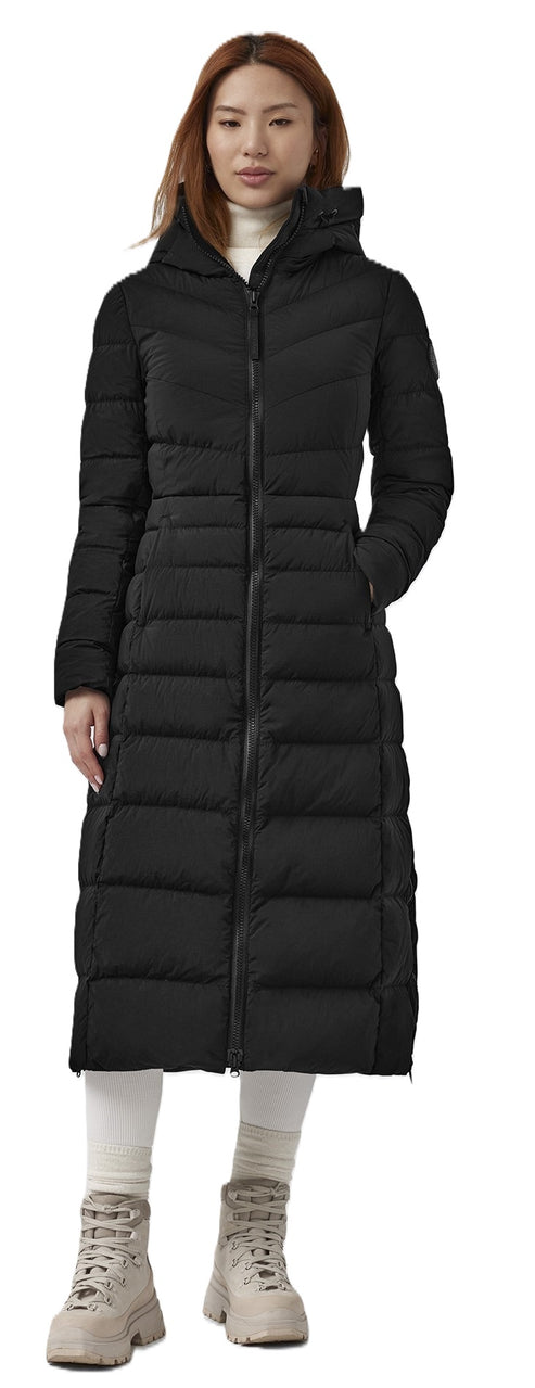 A woman wearing a long, black, puffy coat with a zipper and hood.