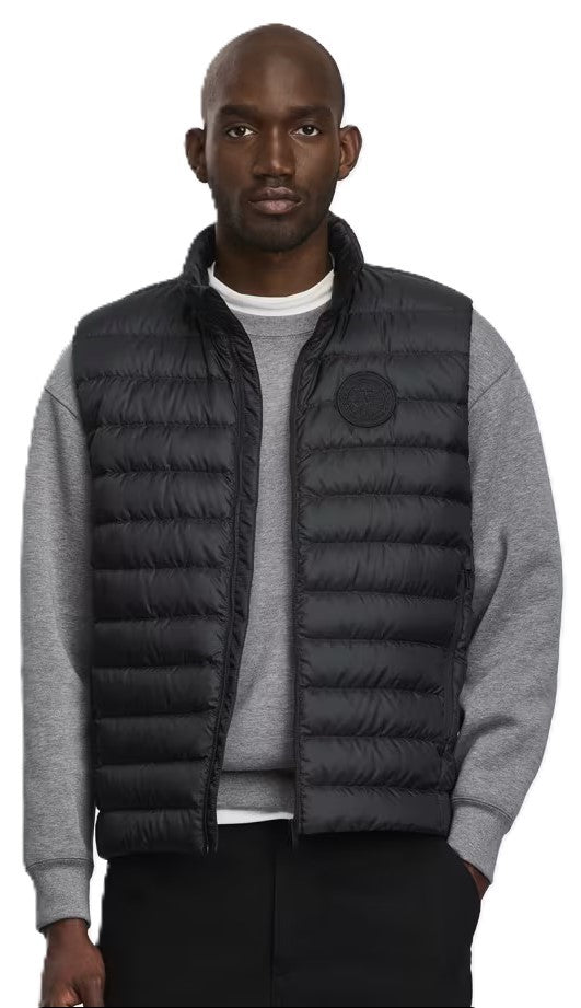 A black down vest on a male model.