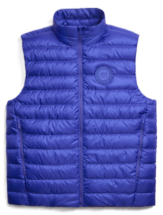 Blue puffer vest with zipper and circular logo on chest.