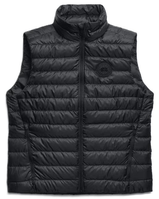 Black quilted vest with a zipper closure and a round logo on the chest.