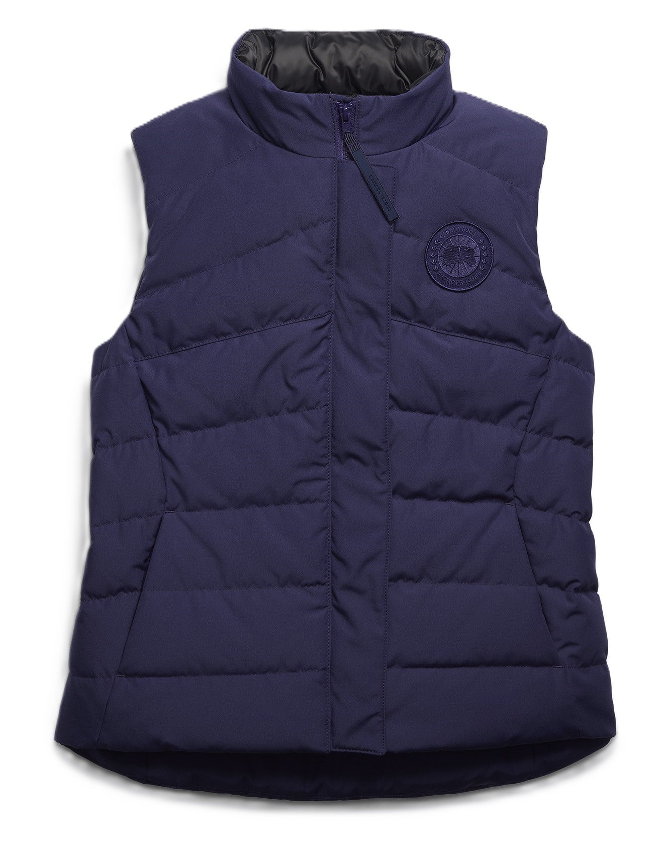 Navy blue quilted vest with a high neck and logo patch.