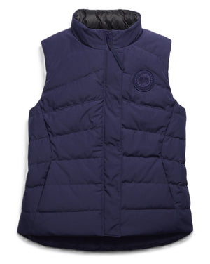 Navy blue quilted vest with a high neck and logo patch.