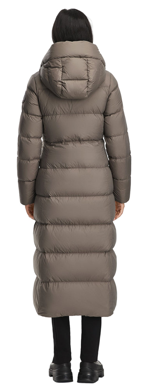 A long, taupe-colored puffer coat with a hood, worn with black leggings and black shoes.