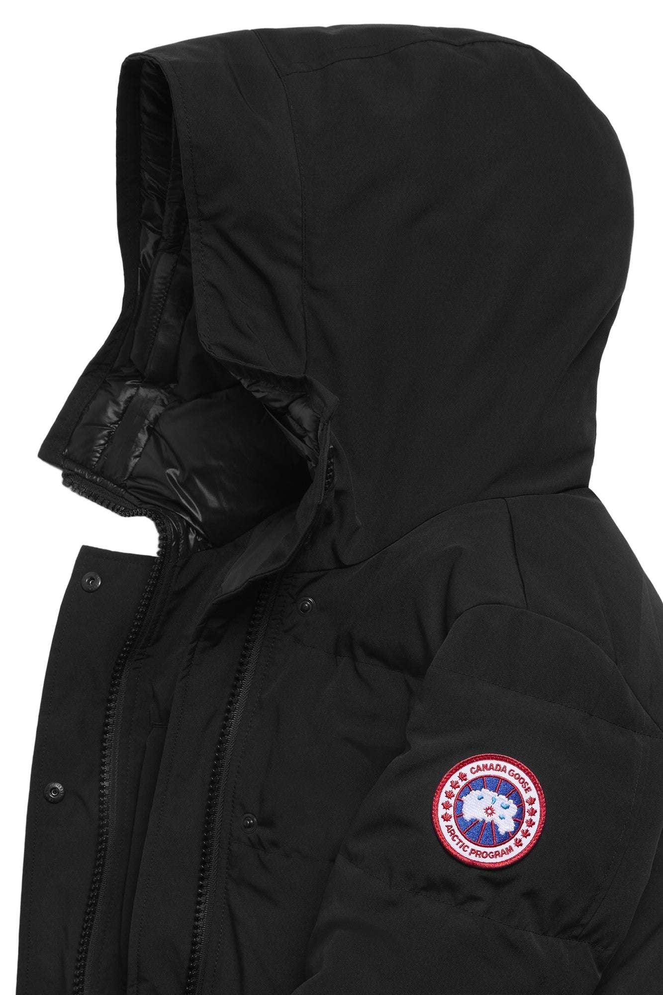 Close-up of a black hooded jacket with a circular logo patch on the sleeve.