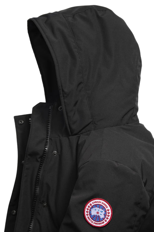 Close-up of black down jacket with hood, zipper and button closure, and badge on sleeve.