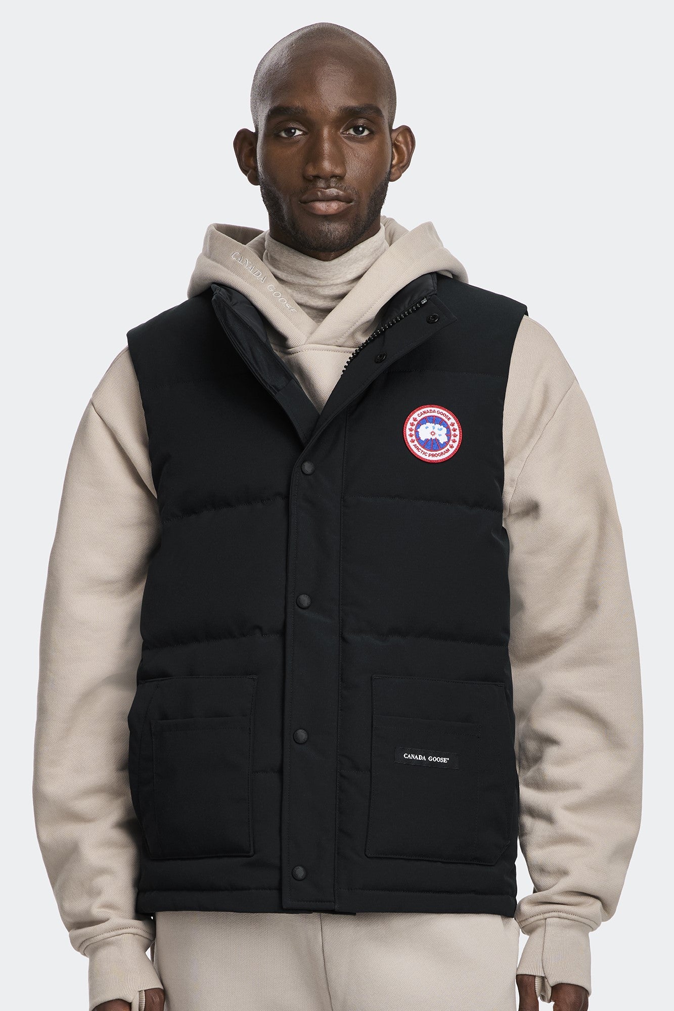 A Black vest with a circular logo on the upper-left and the text "CANADA GOOSE" on the lower-left.