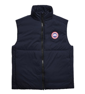 Navy vest with a centered zipper and a round badge logo.