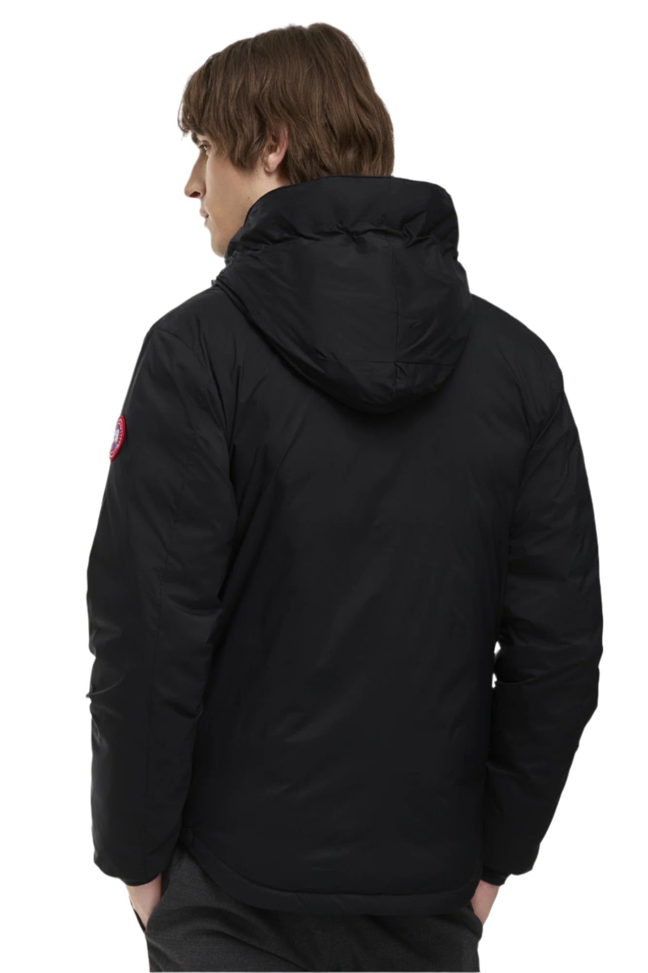 Back view of a person wearing a black winter jacket with a hood.