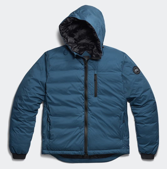 Blue puffer jacket with hood, zippered front, and circular logo patch on left sleeve.