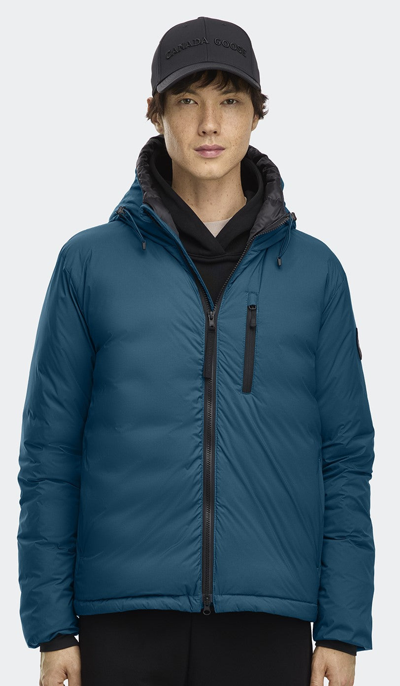 Person in a blue hooded puffer jacket and a black cap.