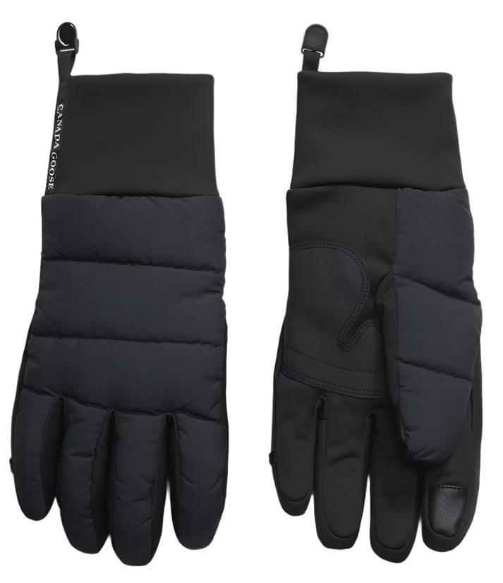 A pair of black winter gloves, one showing the padded top and the other showing the palm, with a logo that says "CANADA GOOSE".