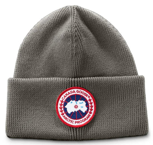 Gray knitted beanie with a red and white circular emblem that reads 'CANADA GOOSE ARCTIC PROGRAM'.