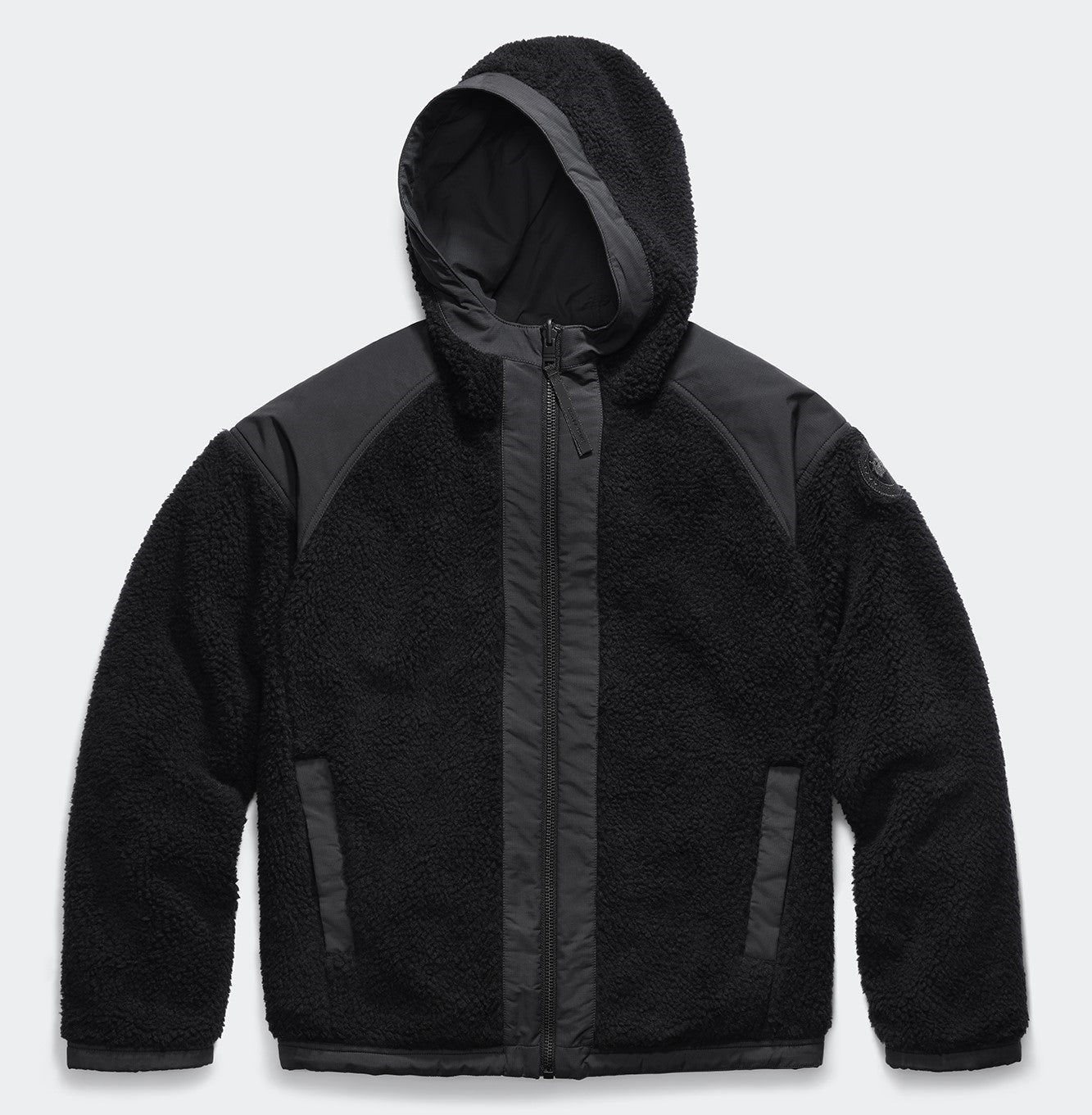 Black fleece hooded jacket with dark nylon trim.