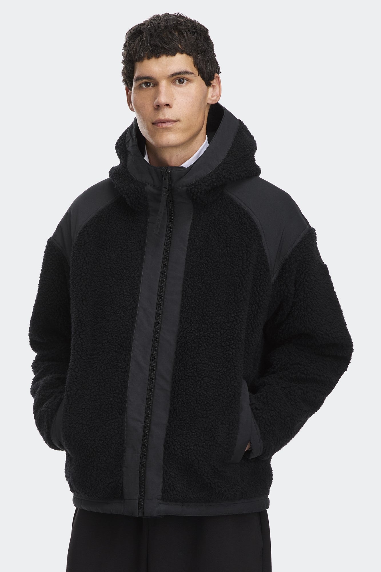 A Black hooded teddy jacket with color-blocked raglan sleeves.