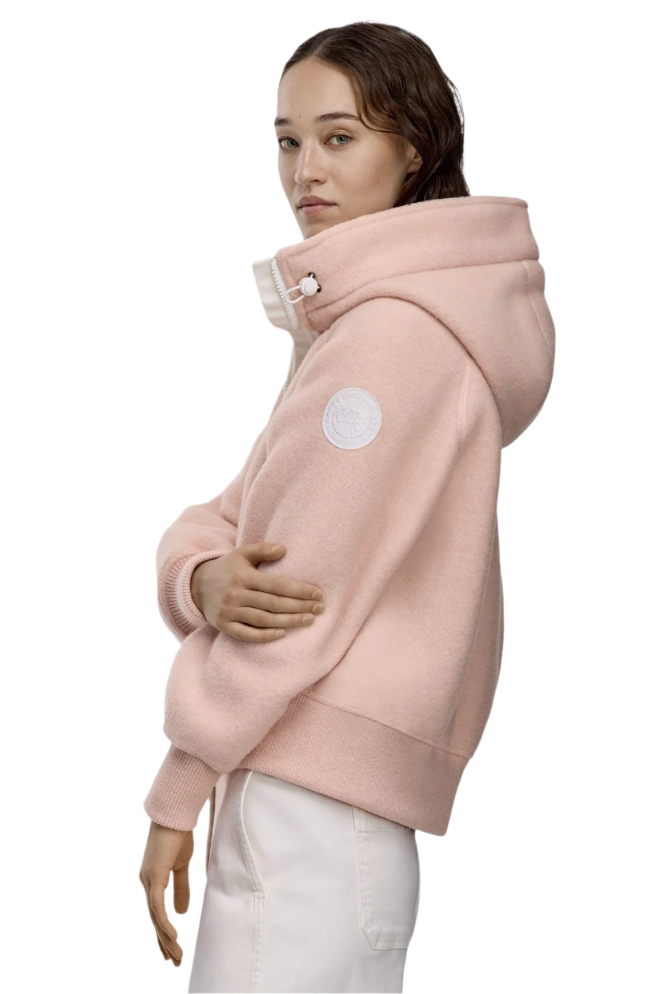 Person in pink hoodie with buttoned collar and white pants