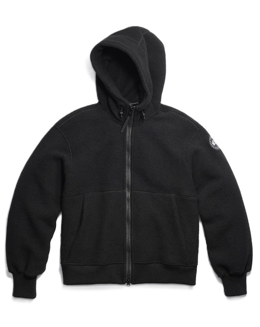 Black hooded zip-up sweatshirt with kangaroo pocket and logo patch on the right sleeve.