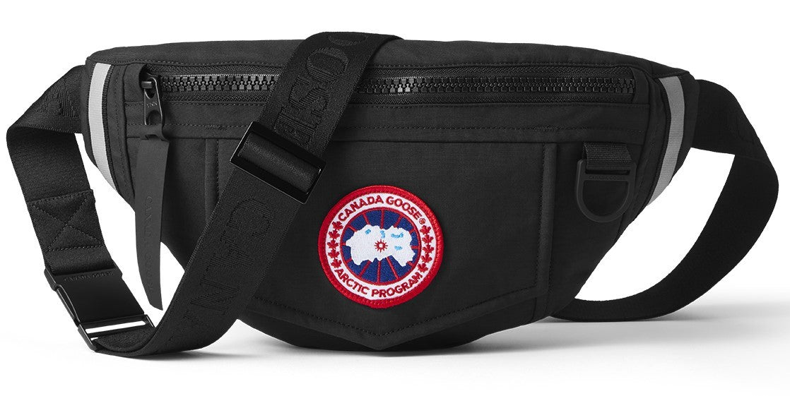 Black fanny pack with adjustable strap and circular patch on the front.