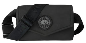 A black bag with a black strap and a circular logo.