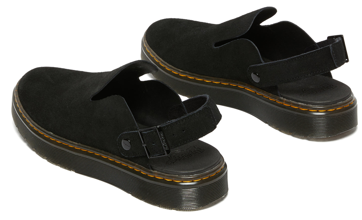 Pair of black suede clogs with adjustable heel straps and yellow stitching.