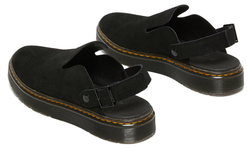 Pair of black suede clogs with adjustable heel straps and yellow stitching.