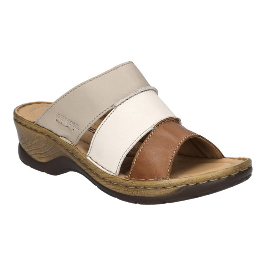 Slide sandal with tan, white, and cream-colored straps.