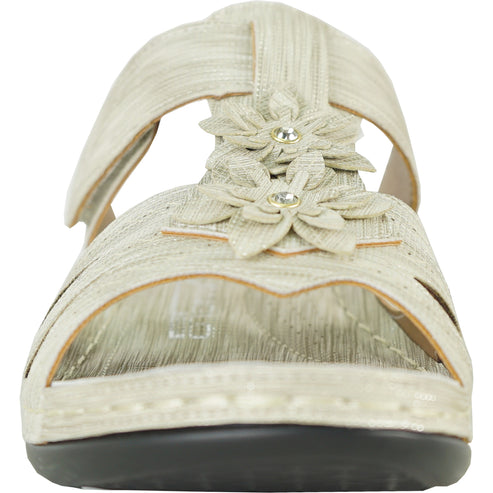 Beige sandal with decorative flower detail.