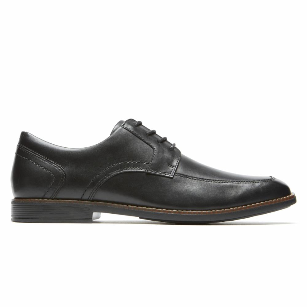 Black leather cap-toe oxford shoe with laces and a flat sole.