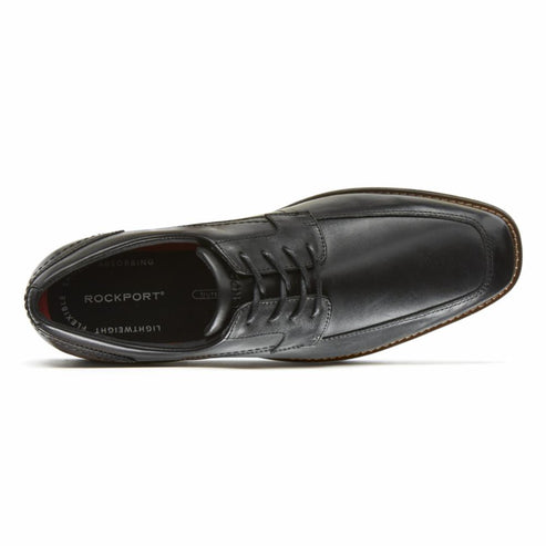 Overhead view of a black leather dress shoe with laces.