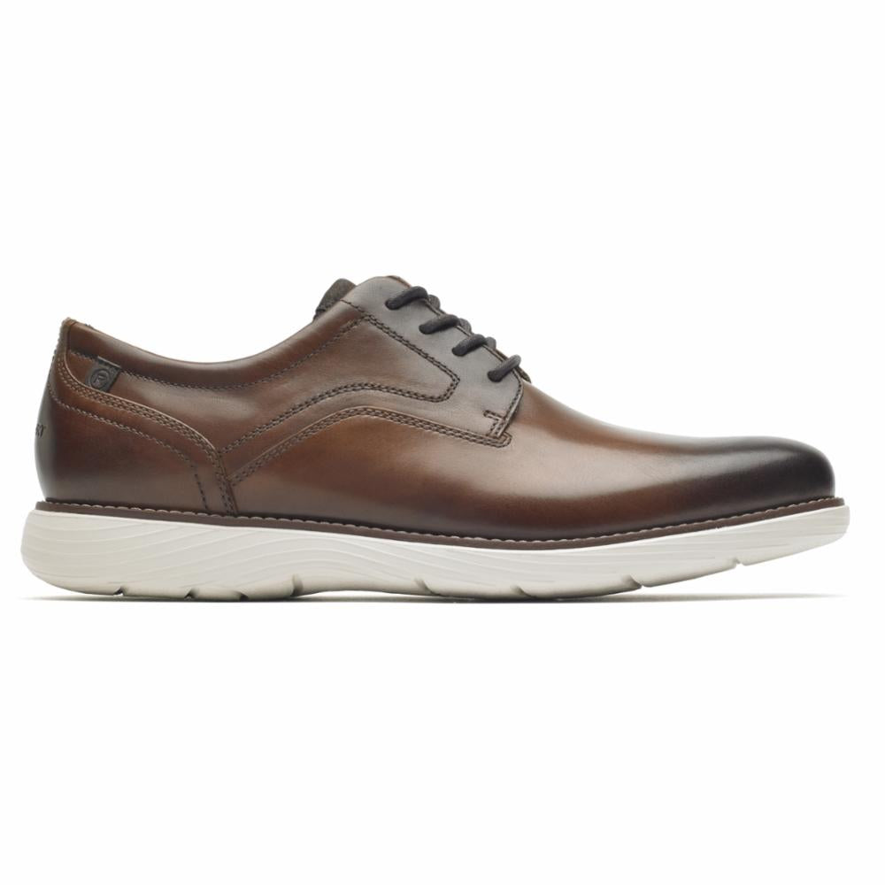 Brown leather lace-up dress shoe with a white sole.