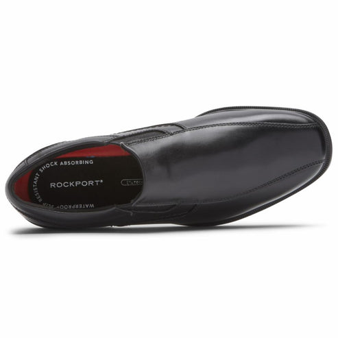 Black leather slip-on dress shoe showing sole with red interior, brand 'ROCKPORT' visible on sole.