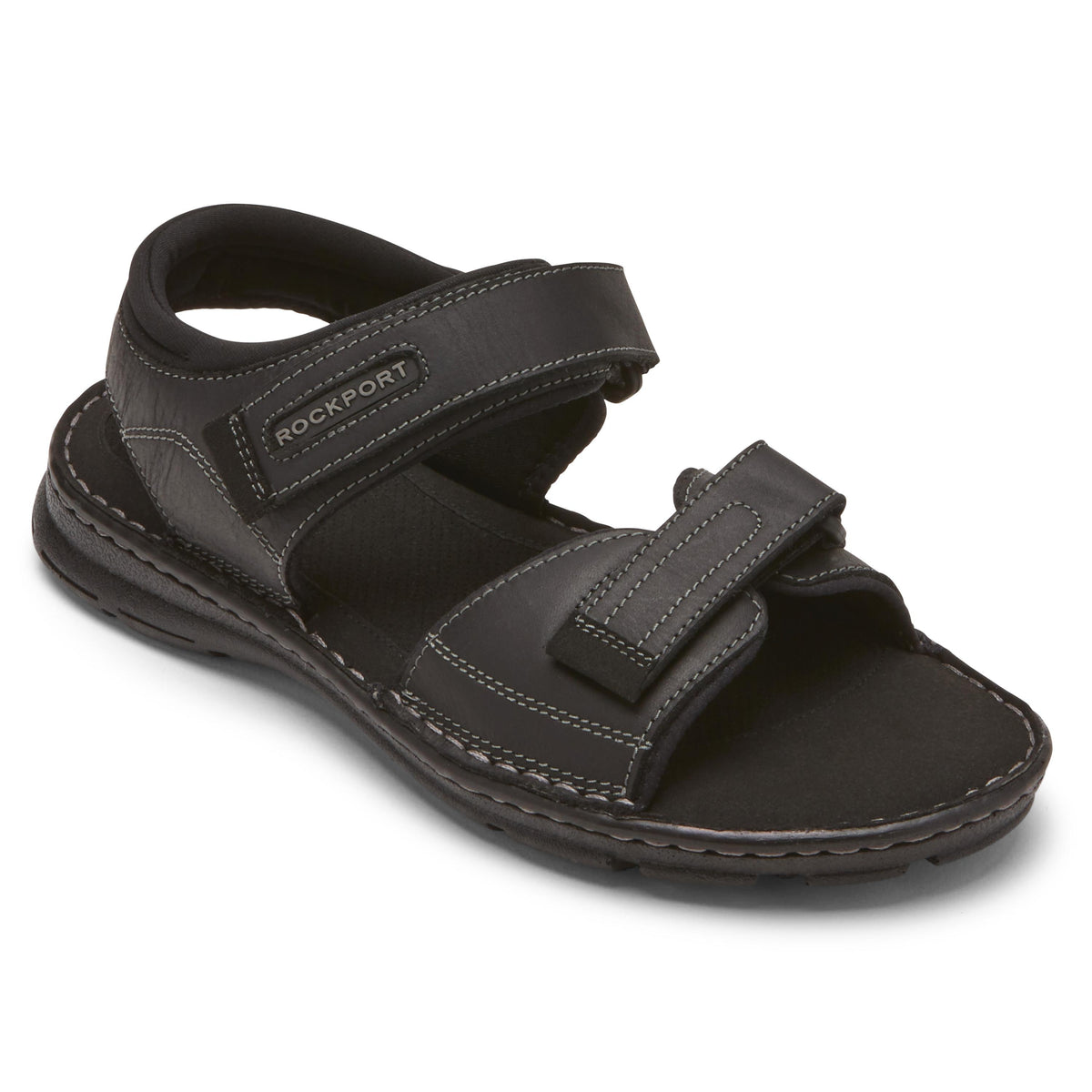 Black leather sandal with two adjustable hook-and-loop straps, and the word "ROCKPORT" on the ankle strap.