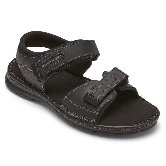 Black leather sandal with two adjustable hook-and-loop straps, and the word "ROCKPORT" on the ankle strap.