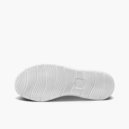 White shoe sole featuring wavy texture and the text "REEF".