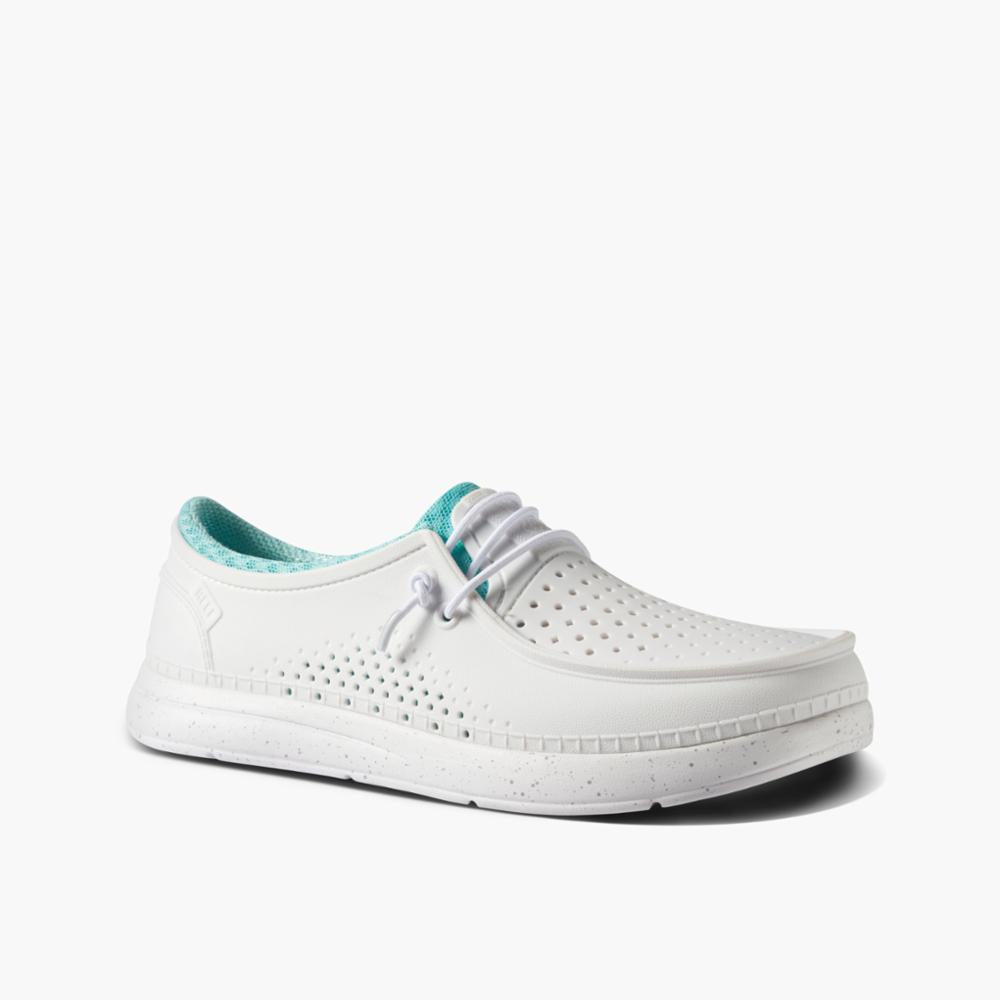 White slip-on shoe with perforated details and teal lining.