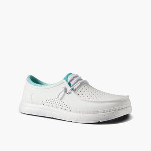 White slip-on shoe with perforated details and teal lining.