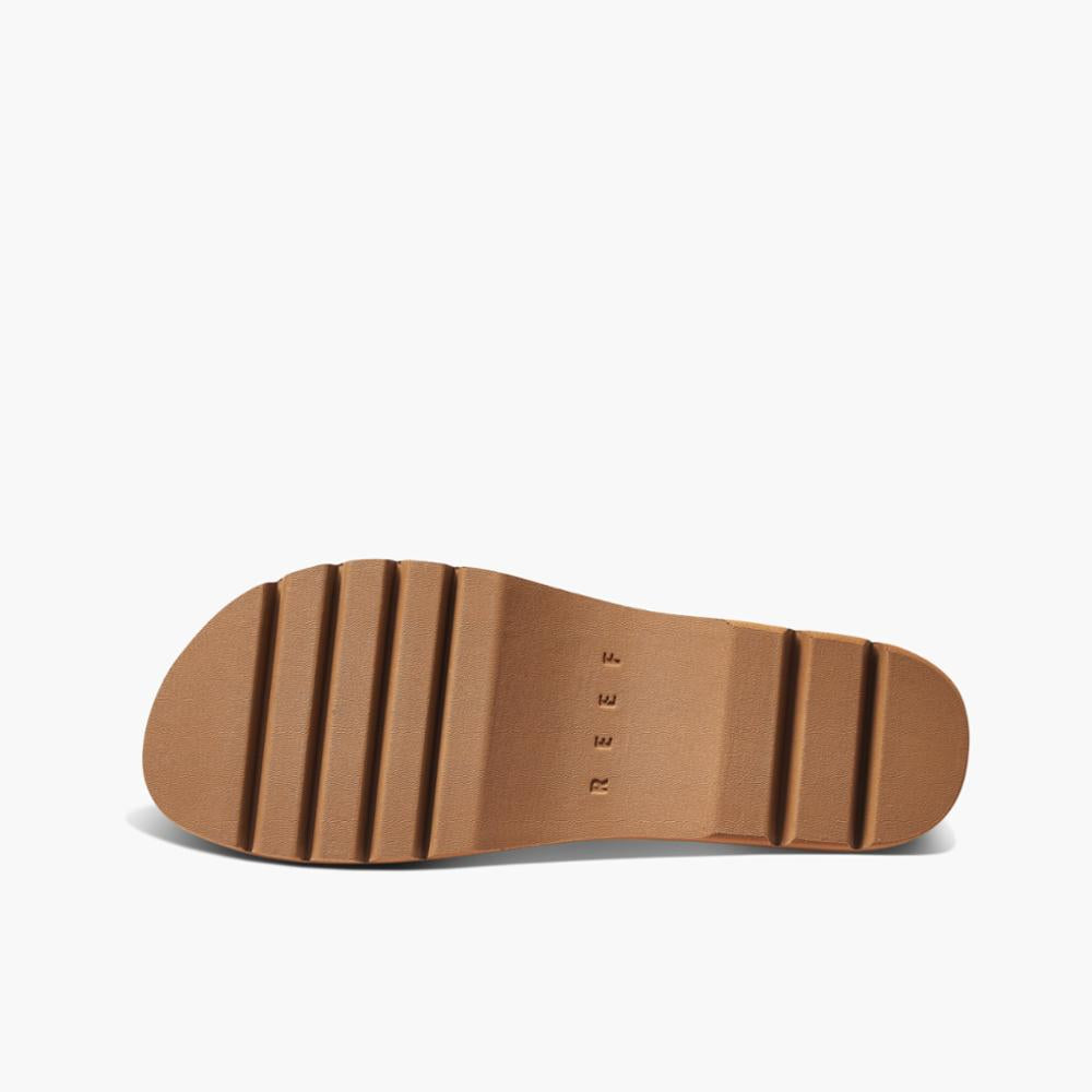 Tan sandal bottom with a thick sole and embossed REEF text.