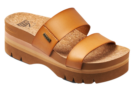 Tan platform sandal with two straps, cork footbed, and "REEF" tag.
