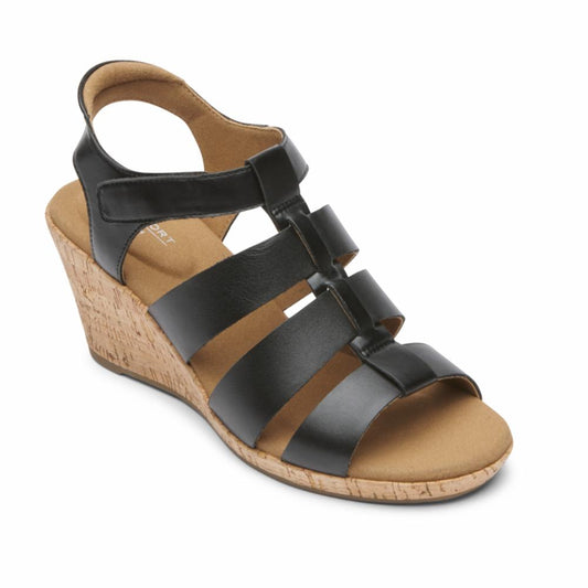 Black wedge sandal with faux cork platform, and multiple straps across the foot.