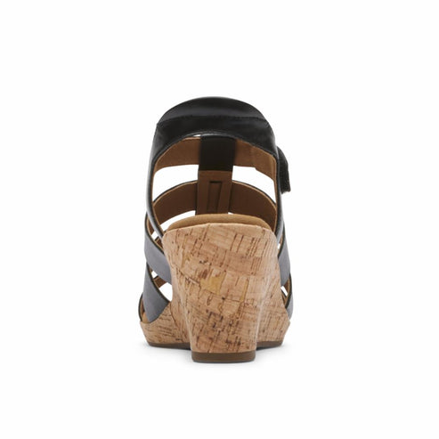 Black wedge sandal with cork heel and cross-strap design.