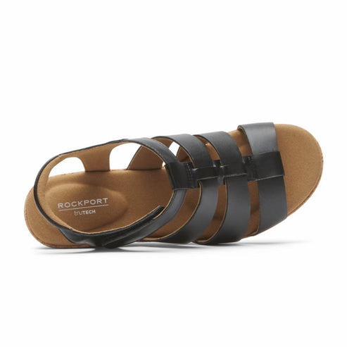 Close-up of a black leather sandal with multiple horizontal straps and a slingback, revealing the lightly cushioned insole and the text "ROCKPORT TRUTECH".