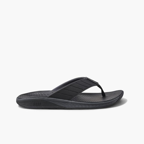 Black flip-flop sandal with textured footbed and striped strap.
