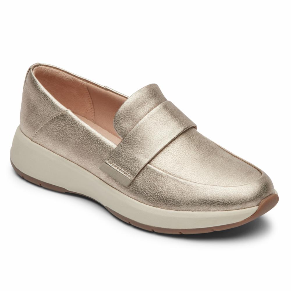 Gold metallic penny loafer with a low white wedge sole.